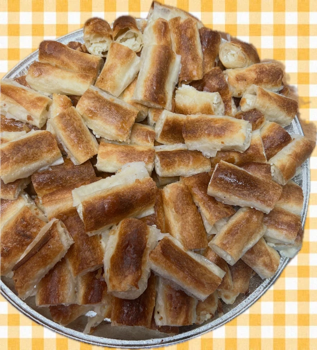 Tray of hand-stretched burek cut into squares
